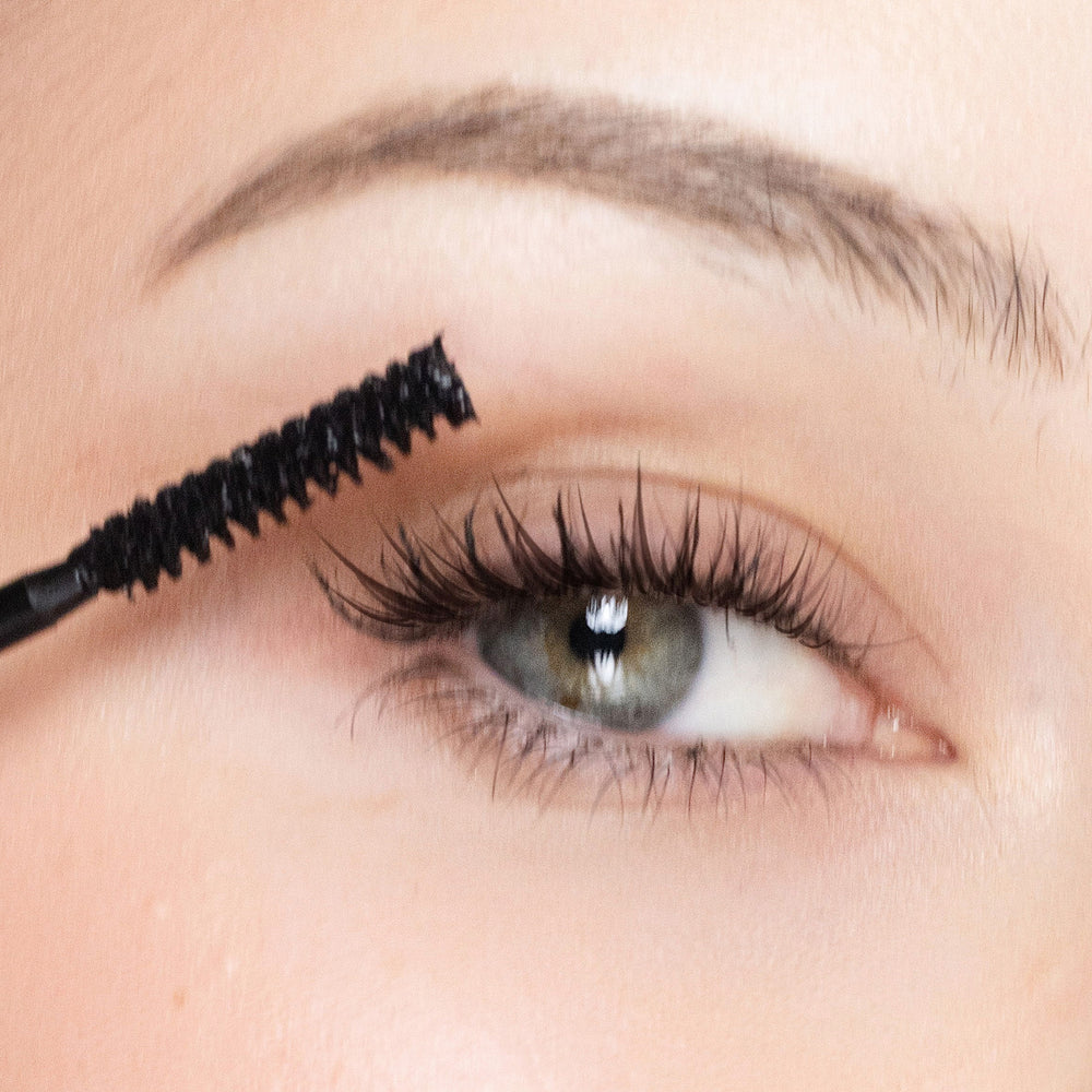 Close-up of an eye with mascara being applied