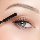 Close-up of an eye with mascara being applied
