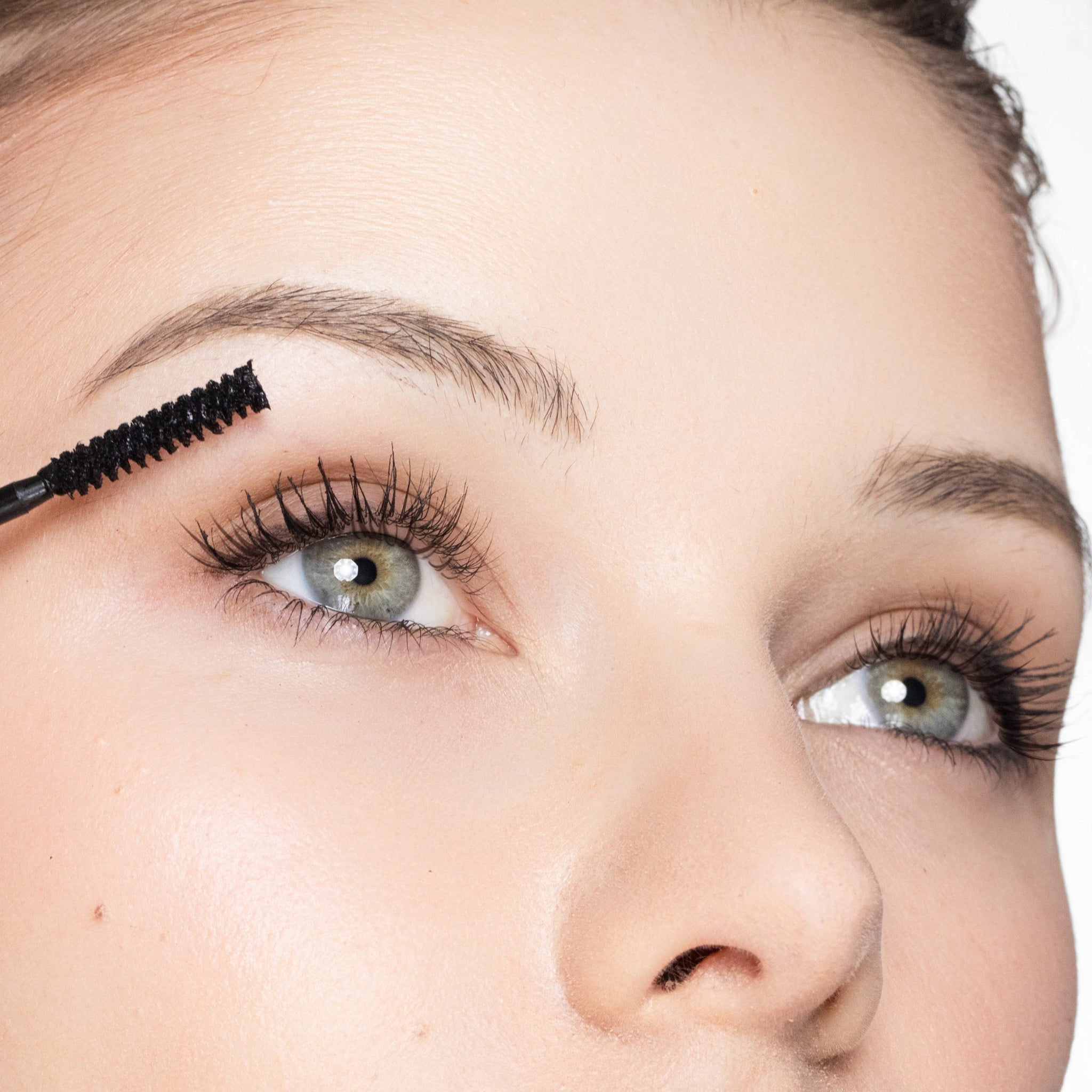 Close-up of an eye with mascara being applied