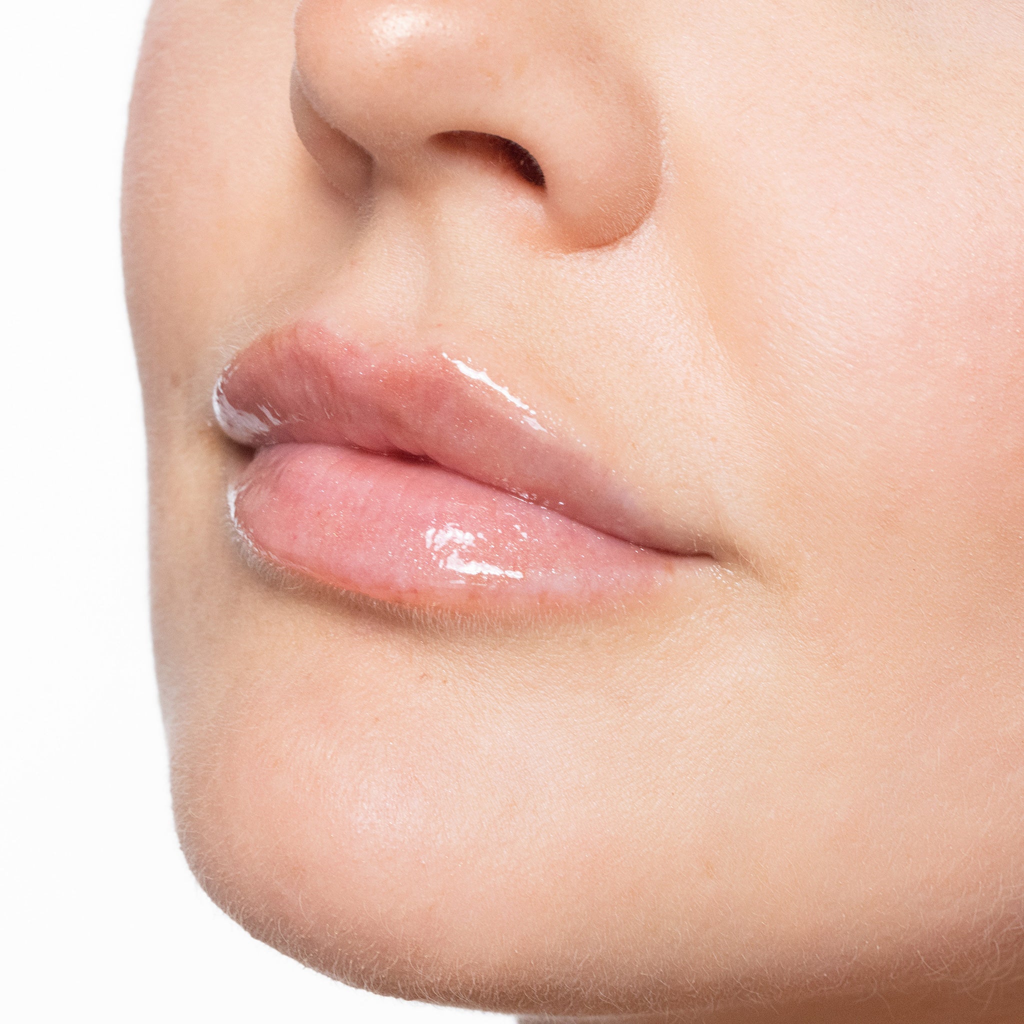 Close-up of a person's lips with a color sexy nude lip gloss