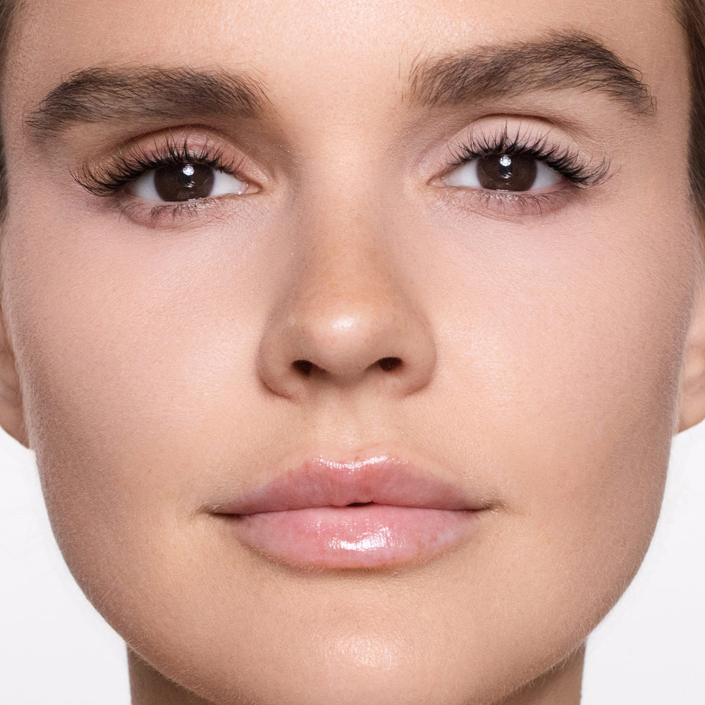 Close-up of a woman's face with color bare eye base 