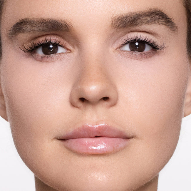 Close-up of a woman's face with color bare eye base 