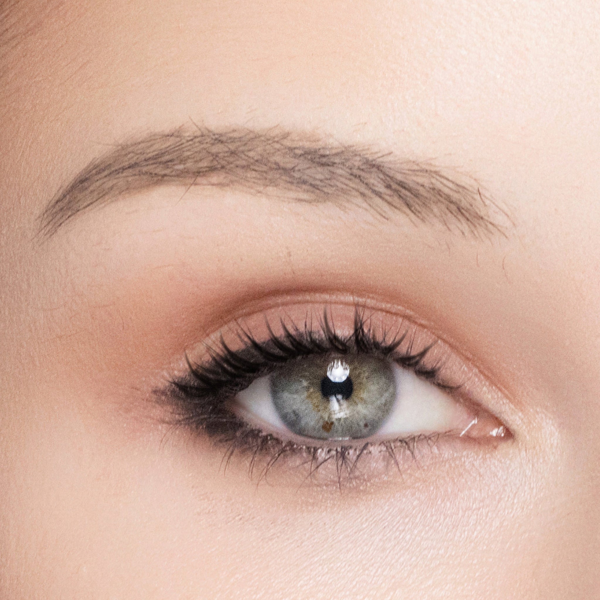 Close-up of a person's eye with color inspired eye shadow makeup
