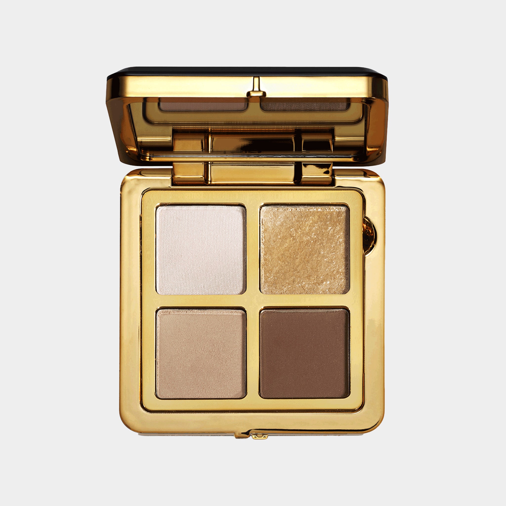 Eyeshadow palette with four colors in a gold case on a white background