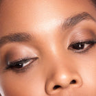 Close-up of a person's eye with color rich brown makeup
