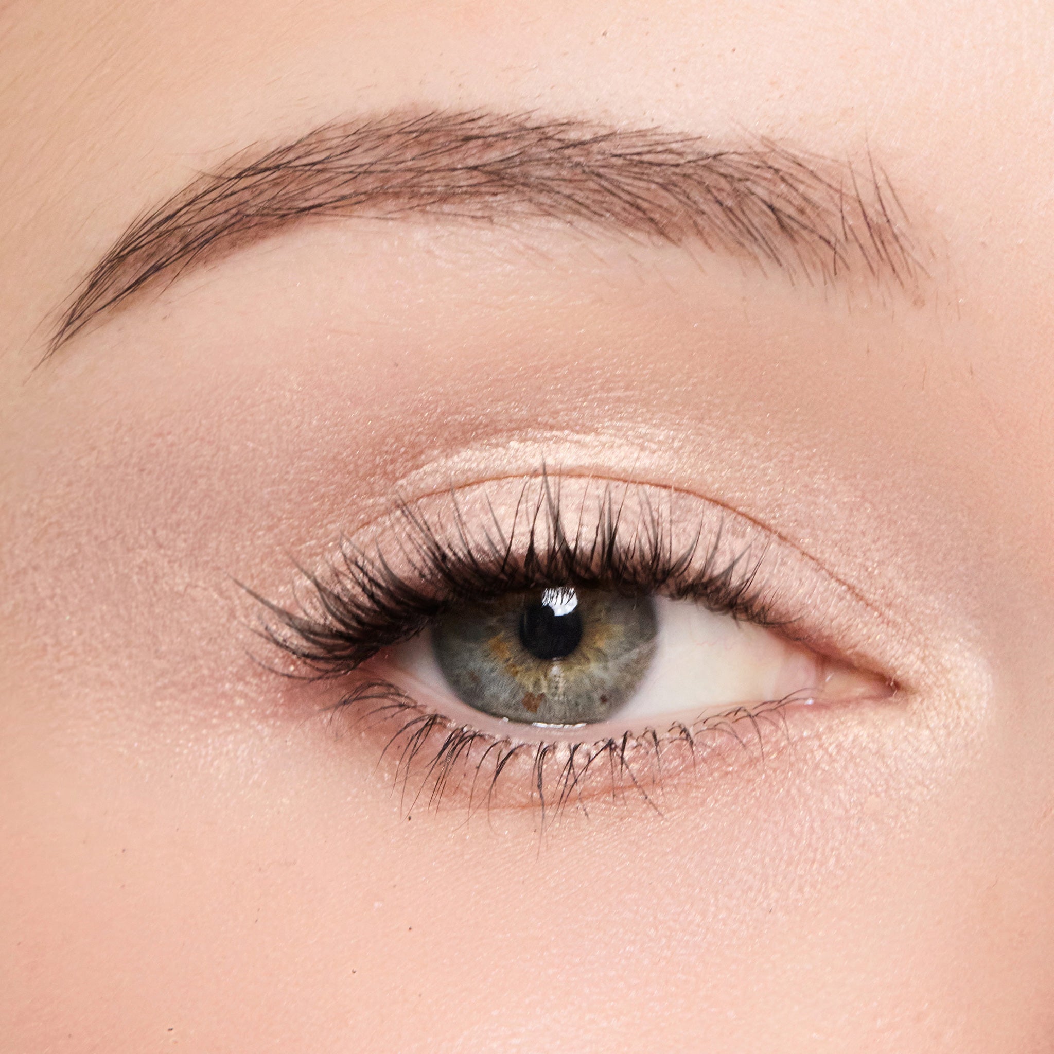 Close-up of a person's eye with color white peach makeup
