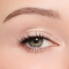 Close-up of a person's eye with color white peach makeup