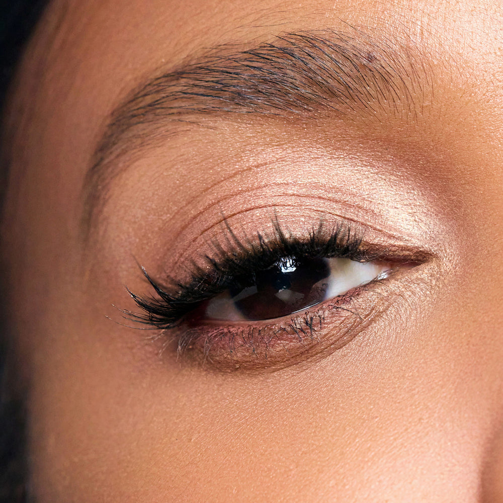 Close-up of a woman's eye with color white peach makeup