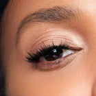 Close-up of a woman's eye with color white peach makeup