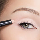 Close-up of a person applying color Shell eyeliner