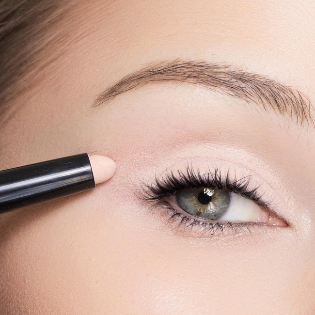 Close-up of a person applying color Shell eyeliner