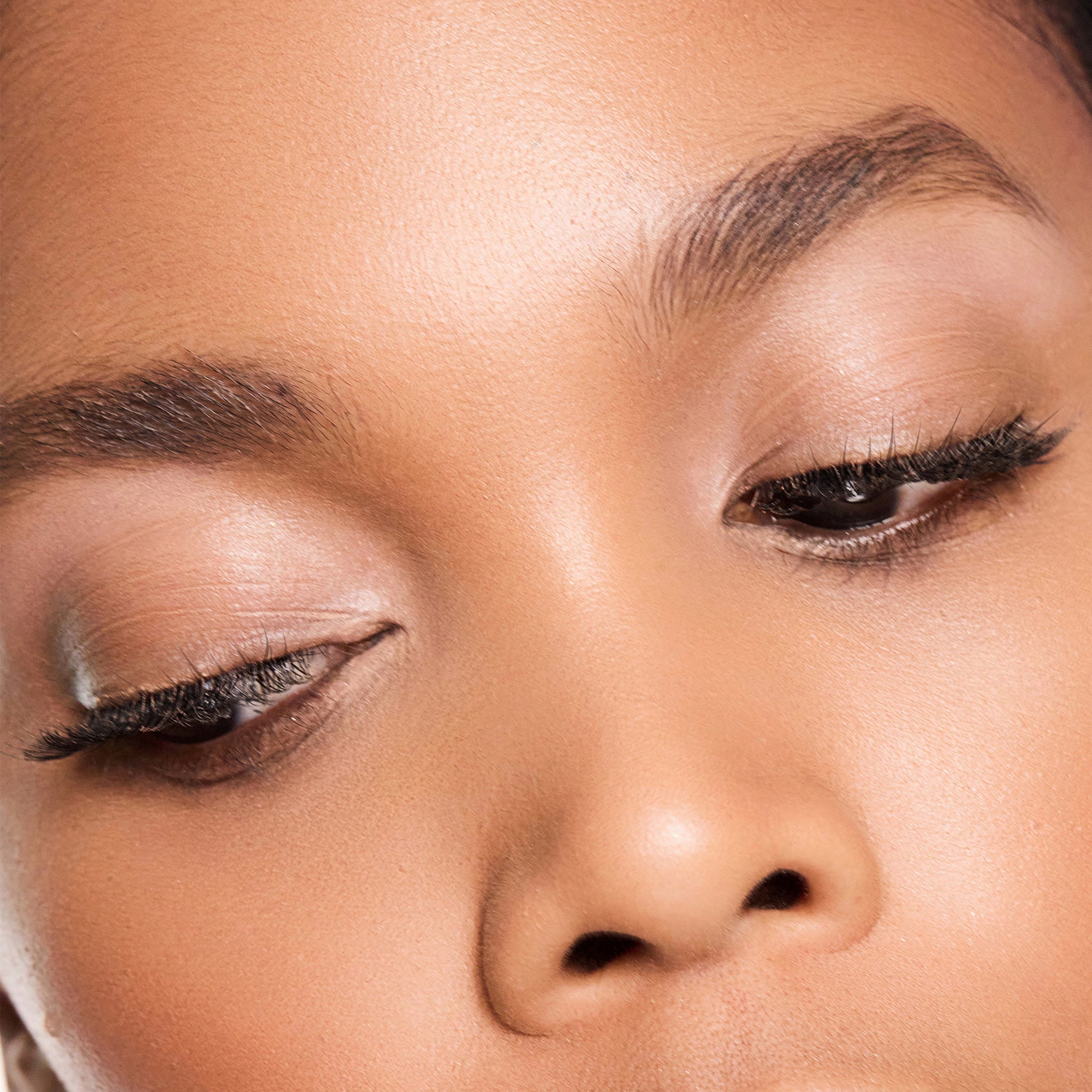 Close-up of a person's face with colour shell makeup on their eyes