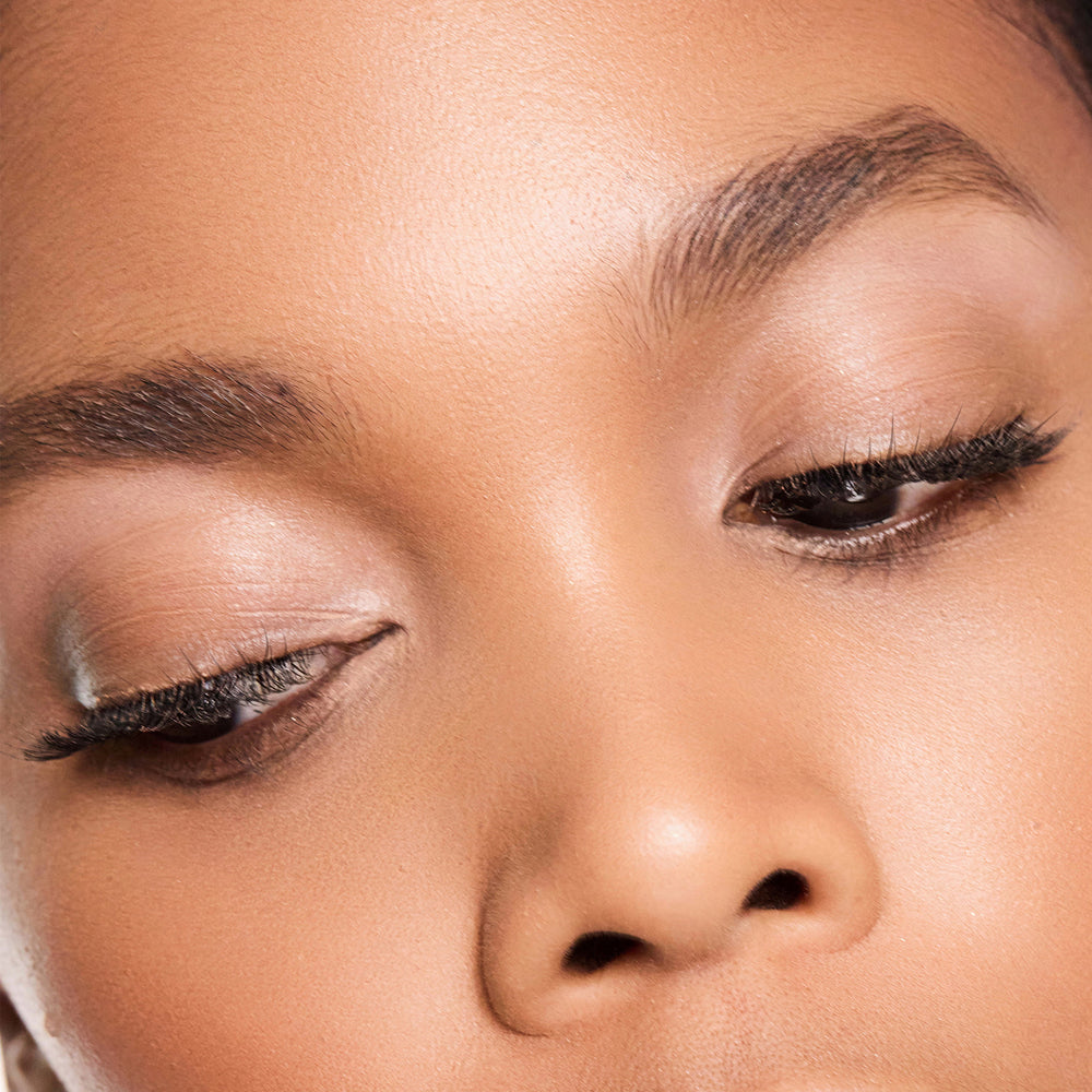 Close-up of a person's face with colour shell makeup on their eyes