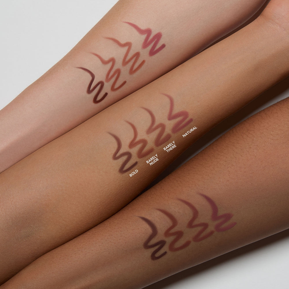 Three swatches of a brown lipstick on different skin tones.
