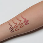 swatches on a person's arm with a neutral background