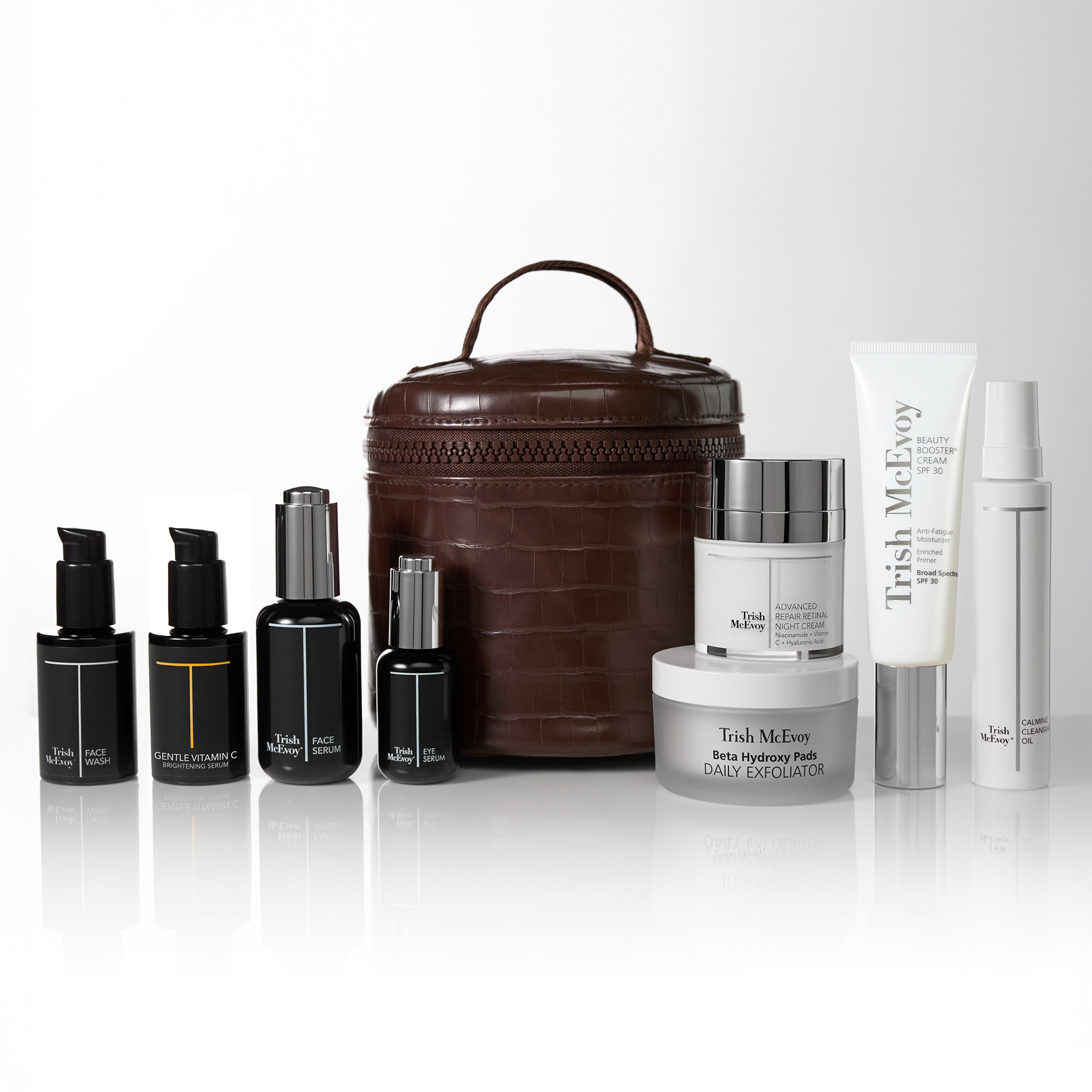 Collection of Trish McEvoy skincare products in a brown crocodile  bag on a white background.