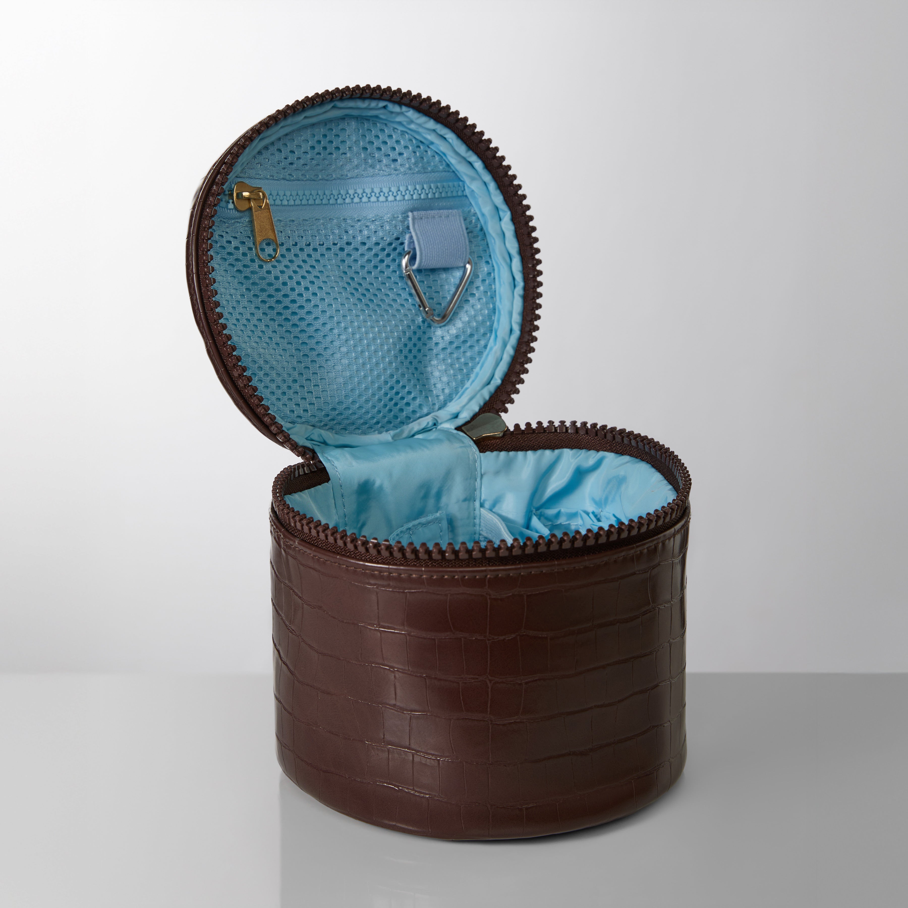 Brown round leather container with blue interior on a white background