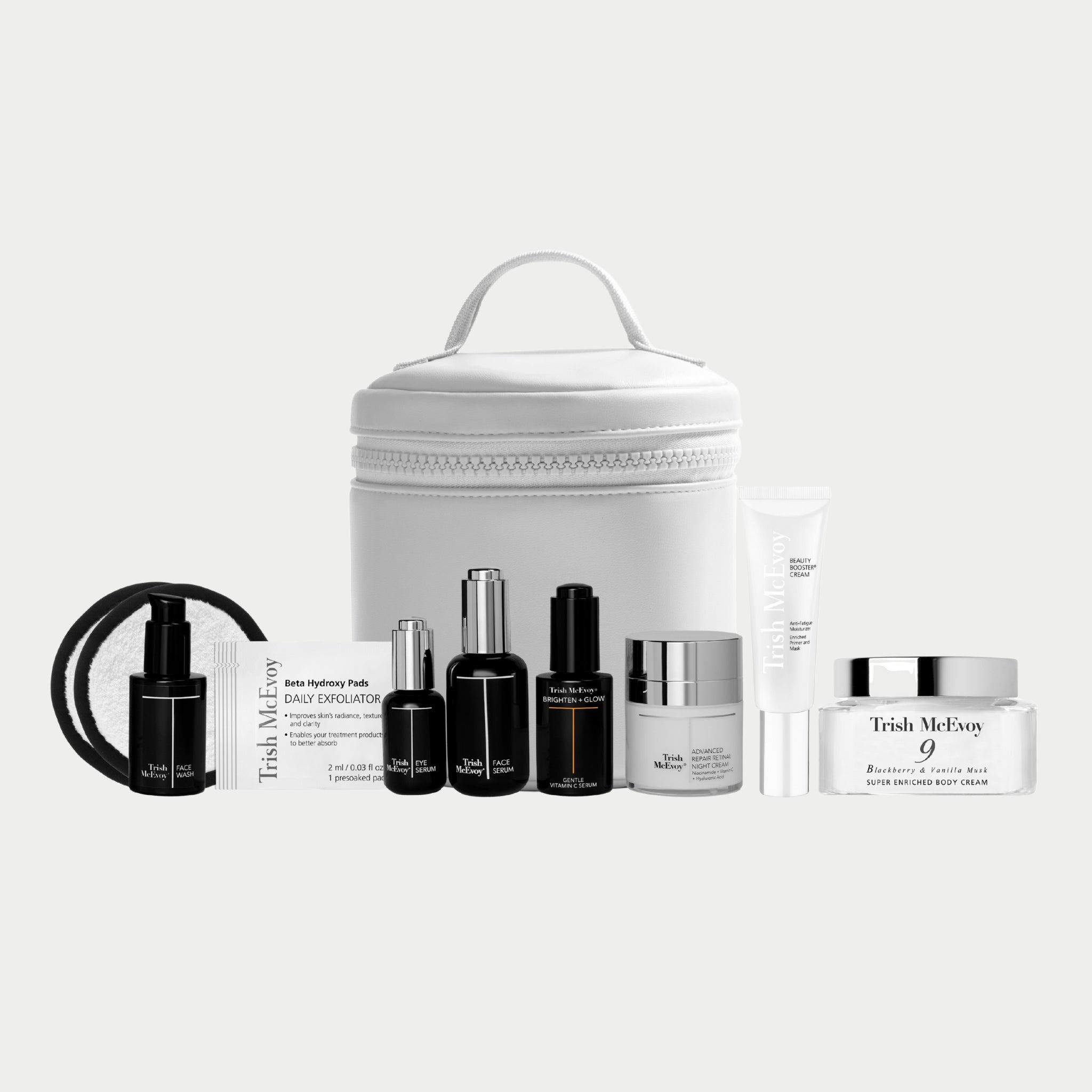 Trish McEvoy skincare products including bottles, jars, and a white travel case on a white background.