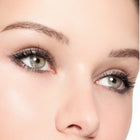 Close-up of a person's eyes with color crystal grey makeup on a white background