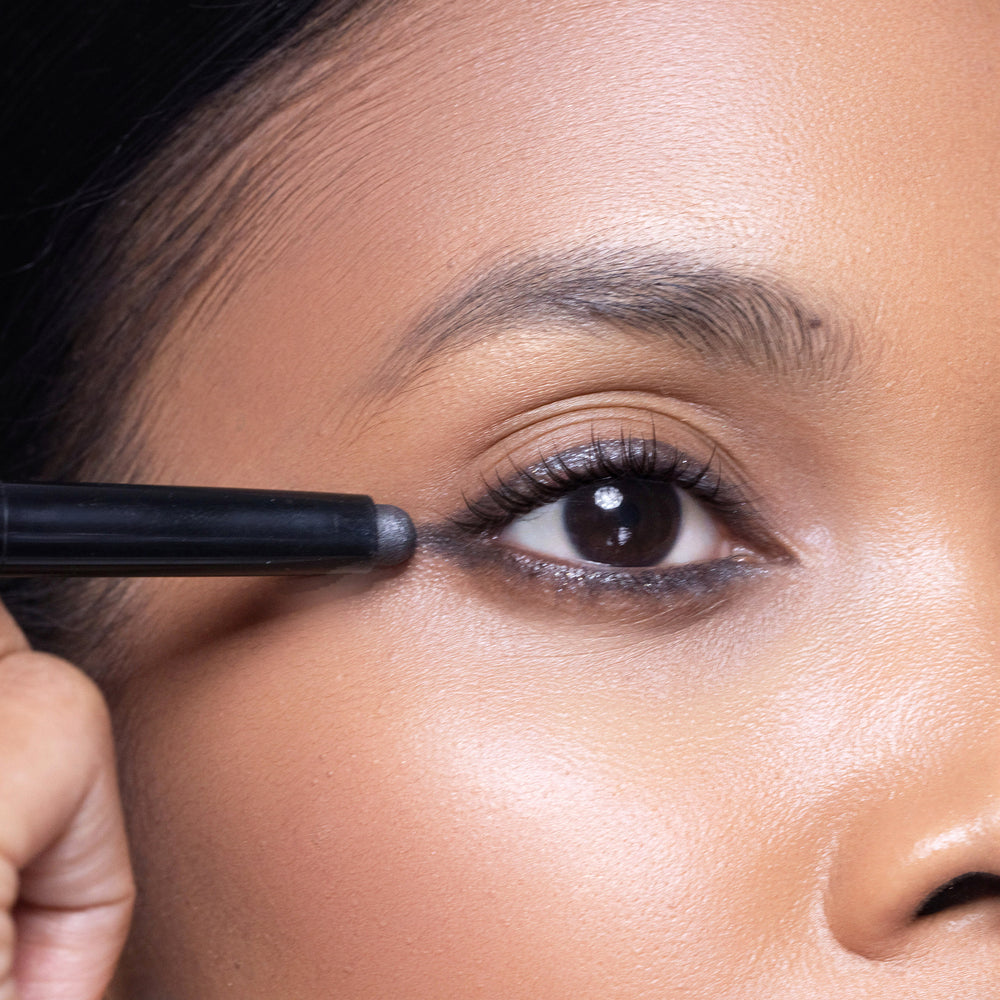 Person applying crystal grey eyeshadow to their eye