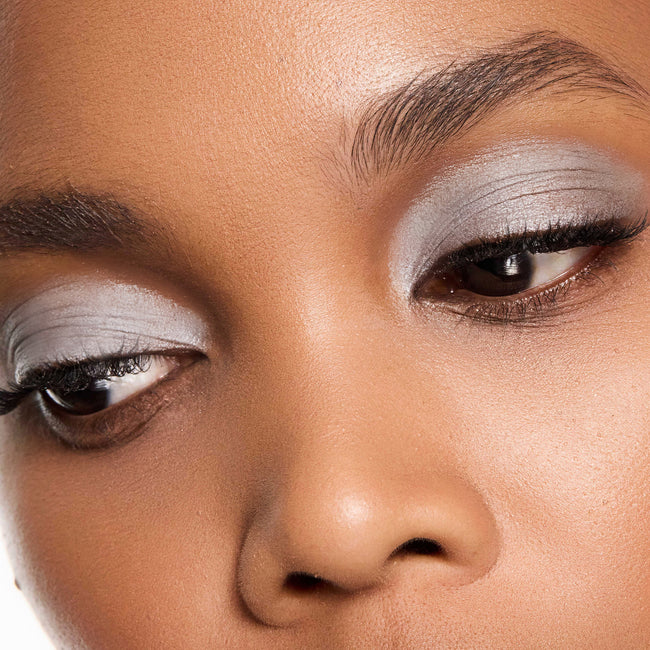 Close-up of a woman's face with color dove eye makeup