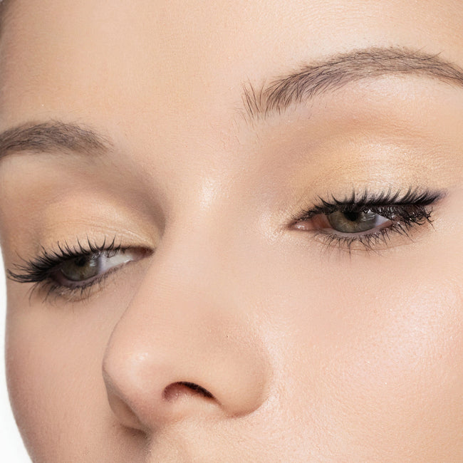 Close-up of a woman's face with color Bone eyeshadow makeup on her eyes