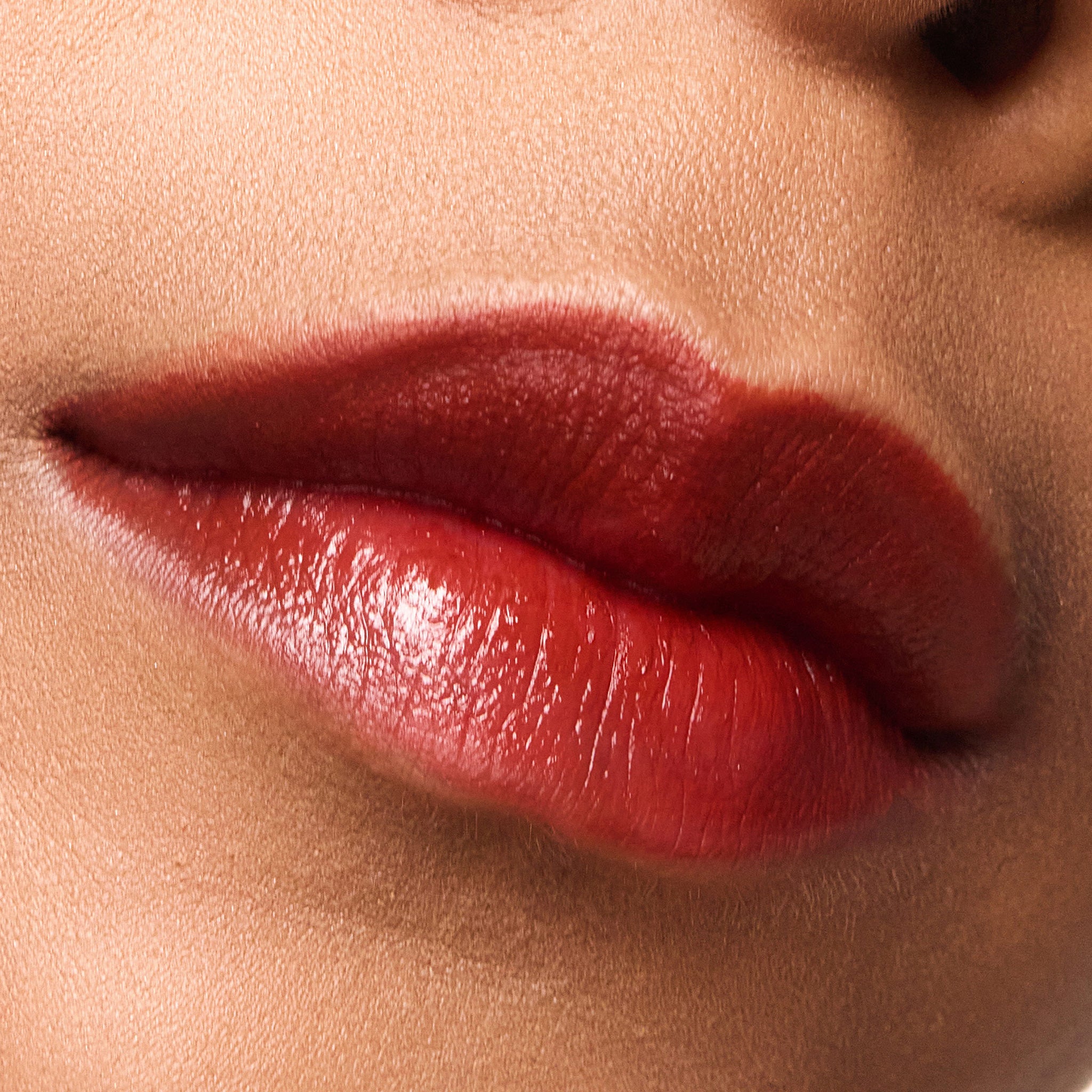 Close-up of a person's lips with color bordeaux lipstick on a neutral background