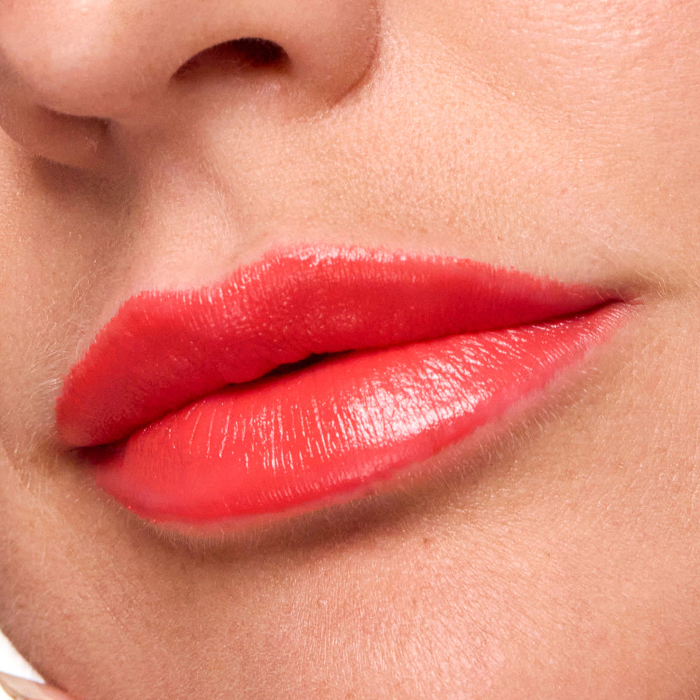 Close-up of a person's lips with beautiful lipstick on a neutral background