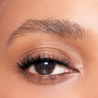 Close-up of a woman's eye with color gold makeup