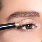 color gold eyebrow pencil being used on an eye with a close-up view