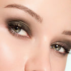Close-up of a woman's eyes with sultry green eye makeup