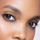 Close-up of a person's eyes with sultry green eyeliner.