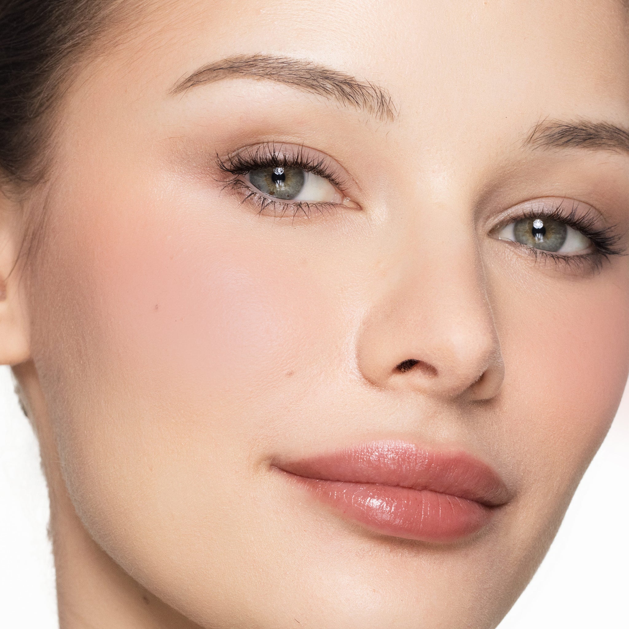 Close-up of a woman's face with a neutral background