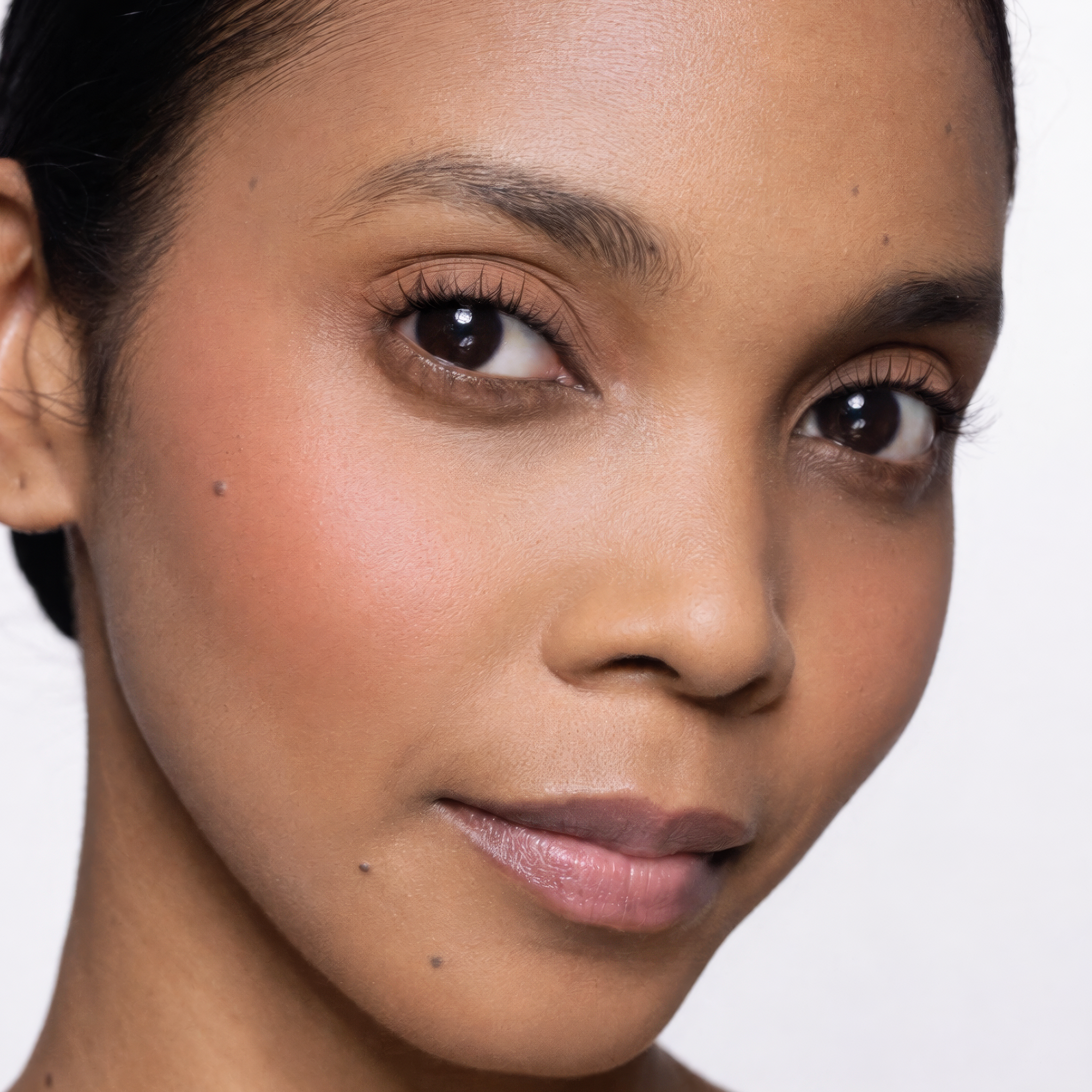 Close-up of a woman's face with a neutral background