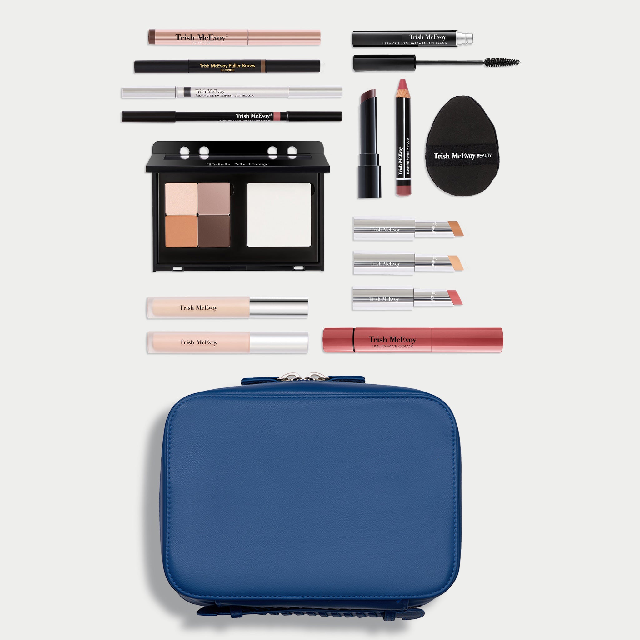 A makeup set arranged on a light gray background with a blue zippered case at the bottom and various cosmetic items above it, including eyeshadow, pencils, lip products, and a black sponge. The visible brand text reads Tatch McEwan.