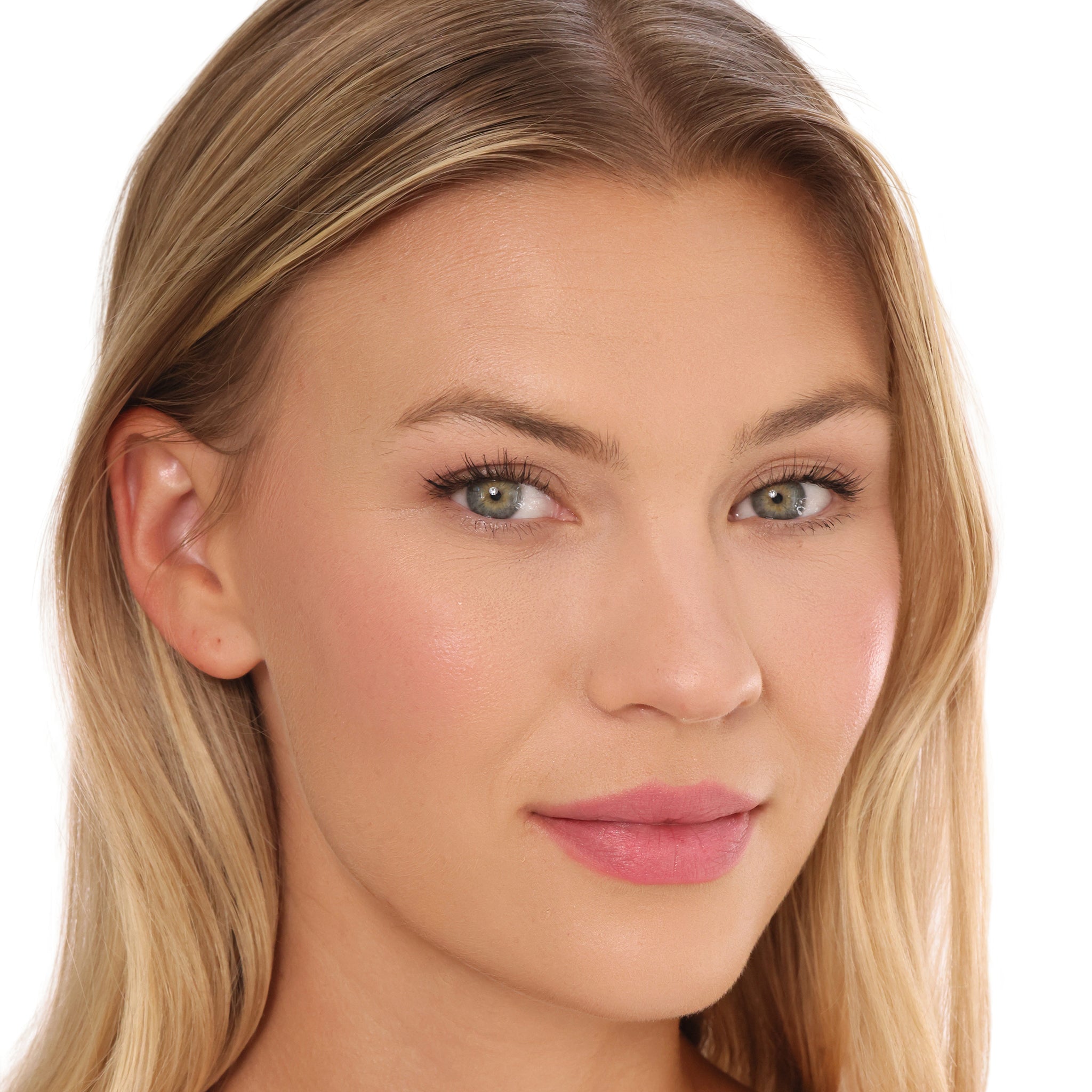 Woman with blonde hair wearing sheer pink lip balm on lips.